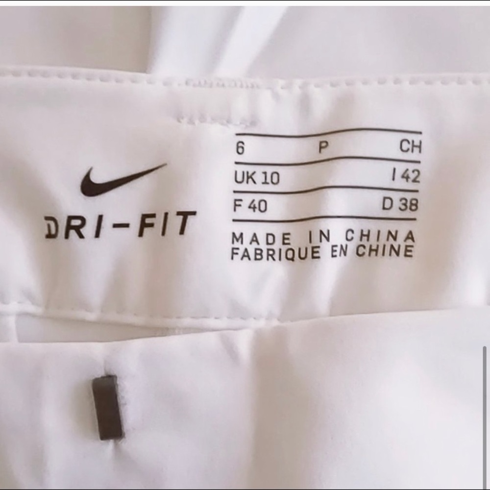 Women's Nike size 6 stretch white gold pants. NWT